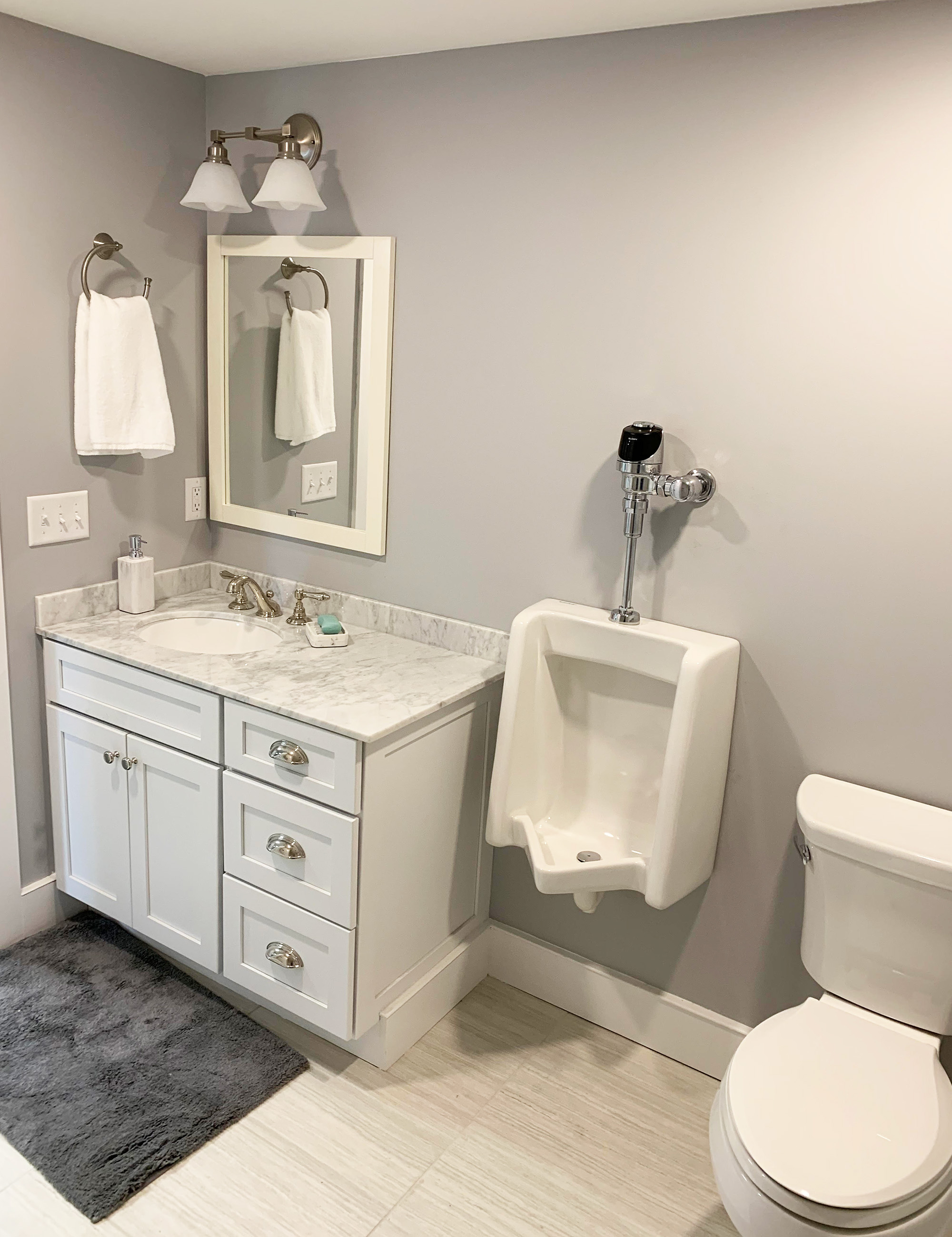 Complete bathroom remodel including sink, vanity, fixtures, toilet, and plumbing.