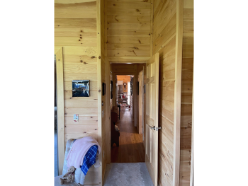 View of the hallway from the wood panel bedroom.