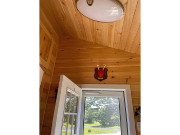 Wood slats at a unique angle around door entryway