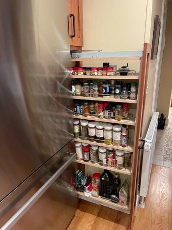 Custom spice rack for space saving solution next to the refrigerator. 