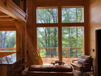 Looking out upon the river from within wood cabin.