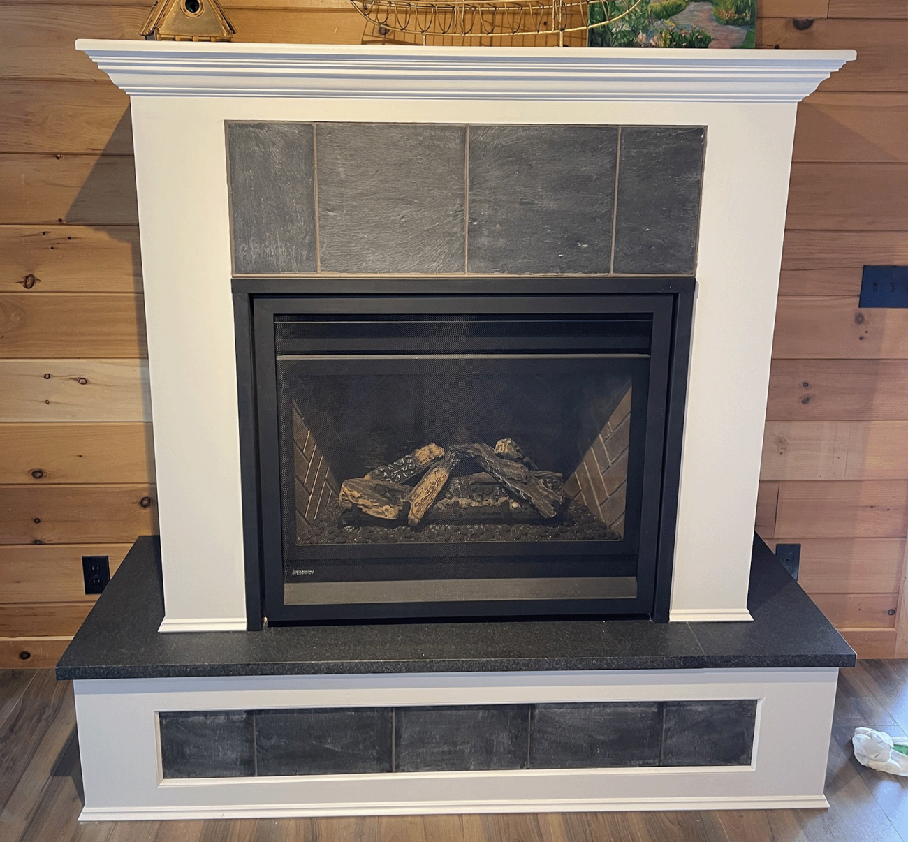 Custom designed and built fireplace surround with hearth and mantelpiece complete with slate insets.
