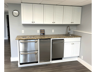 kitchenette with under-the-counter appliances such as mini-fridge and dishwasher.