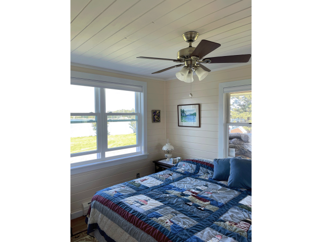 Coastal bedroom with painted cream shiplap.