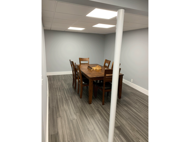 The basement dining area with wood floors.