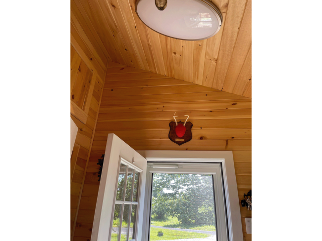 Wood slats at a unique angle around door entryway