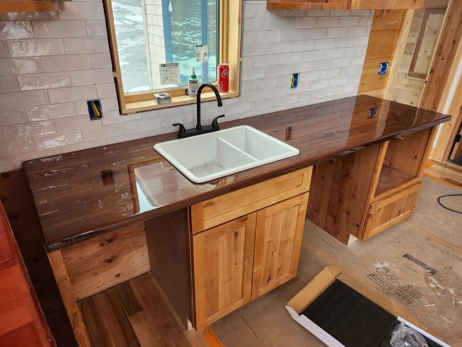Custom wood kitchen countertop and cabinetry installed.