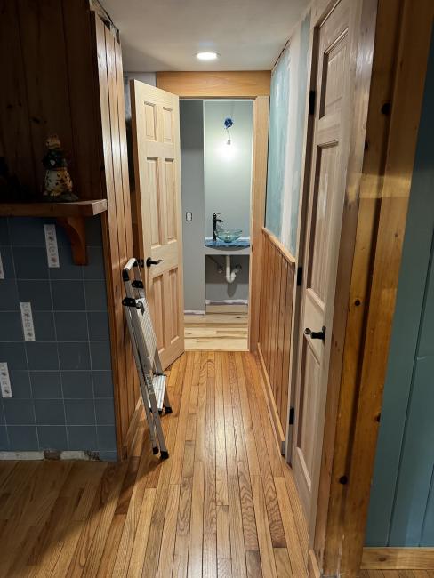 Hallway leading into the newly redone half bath.