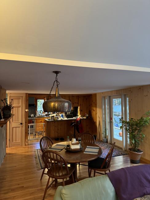 An open concept dining room, living room, and kitchen to expand this Maine cabin.