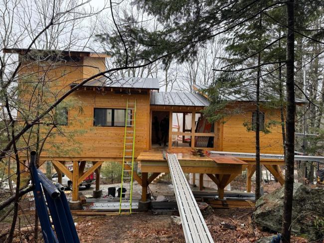 Tree house cabin with breezeway under construction.