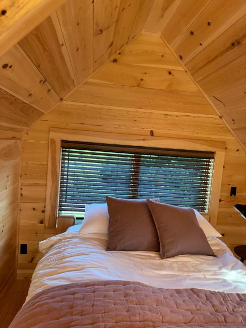 Wood shiplap siding and ceiling in cabin interior.