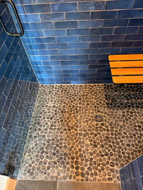 Natural shower floor laid with smooth stones.
