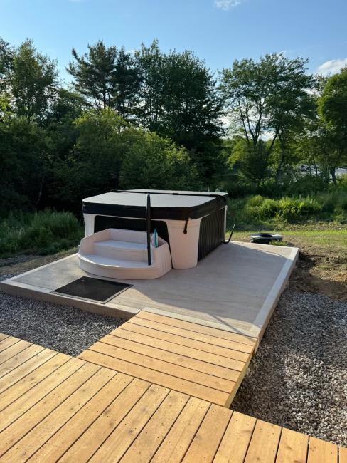 Hot tub installation and patio construction for The Willow cabin.
