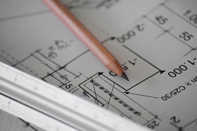 AutoCAD architectural plan up close with a pencil laid upon top.