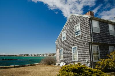 coastal cape cod style home with shingle siding